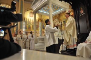 Bishop DiMarzio prays with foursome