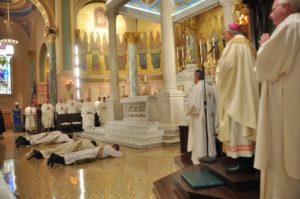 Priests prostrate with bishop