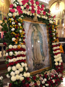 Painting of Our Lady of Guadalupe surrounded with flowers