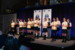Students of St. Stanislaus-Kostka Catholic Academy on stage at the Futures in Education gala for their performance.