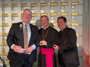 Bishop accepts a award at the Christmas Luncheon