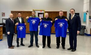 Monsignor John Maloney, Pastor of St. Anselm Roman Catholic Church, Father Kevin Abels, Pastor of Our Lady of Angels, Bay Ridge Catholic Academy Board member George Prezioso, join Dr. Miguel Martinez-Saenz, Robert Oliva, and Principal Gary Williams for a photo.