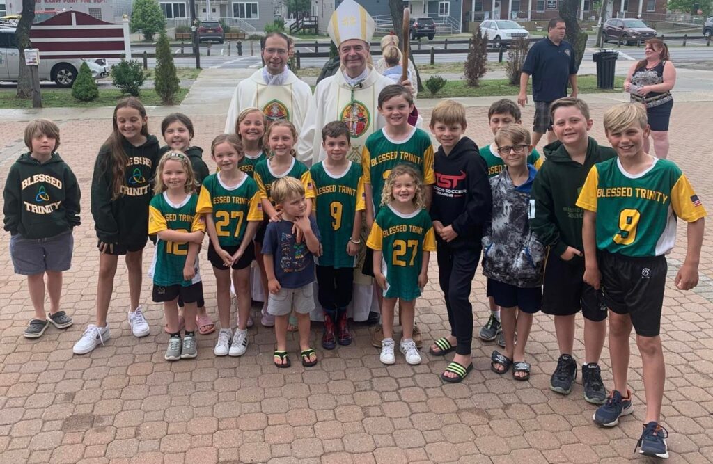 Bishop Robert Brennan with members of the Blessed Trinity Sports Program.