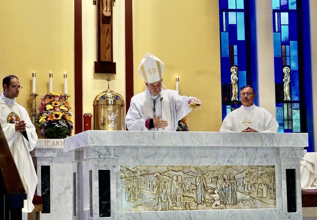 Bishop Brennan blessing the altar at St. Thomas More.