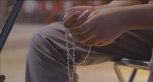 Boy holding rosary